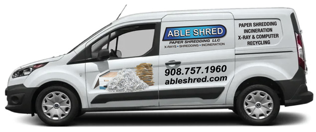 White van with Able Shred logo and contact information on side panels.