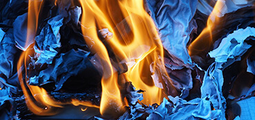 Paper being consumed by flames.