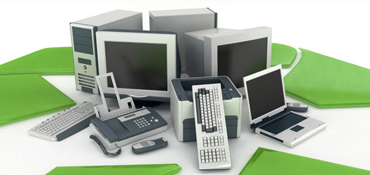Pile of computers, keyborads, laptops, monitors, printers, etc. for recycling.